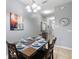 Formal dining room with seating for six, complemented by contemporary decor at 8963 Majesty Palm Rd, Kissimmee, FL 34747