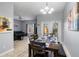 Open concept dining area with patio doors, a living room with gray sofa, and ceiling fan at 8963 Majesty Palm Rd, Kissimmee, FL 34747