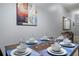 Formal dining room with seating for six, complemented by contemporary decor at 8963 Majesty Palm Rd, Kissimmee, FL 34747