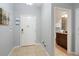 Inviting entryway with a white door, tile floor, and artwork leads to a modern bathroom at 8963 Majesty Palm Rd, Kissimmee, FL 34747