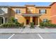 Charming townhome showcasing a well-maintained facade with neat landscaping, covered entries and bright exterior paint at 8963 Majesty Palm Rd, Kissimmee, FL 34747