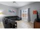 Comfortable living room featuring a sectional sofa, tile flooring and ample natural light at 8963 Majesty Palm Rd, Kissimmee, FL 34747