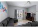 Inviting living room featuring modern decor, cozy seating, and a well-lit window at 8963 Majesty Palm Rd, Kissimmee, FL 34747