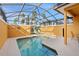 Inviting pool area, palm tree view, and enclosed screen with lounge chairs and seating at 8963 Majesty Palm Rd, Kissimmee, FL 34747