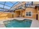 An eye-level view of a pool and an outdoor seating area underneath a screened-in enclosure at 8963 Majesty Palm Rd, Kissimmee, FL 34747