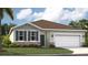 Charming single-story home with a well-manicured lawn, stone accents, and a two-car garage at 912 Pearlwood Loop, Eagle Lake, FL 33839