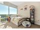 Bright bedroom showcases large window with city views, comfortable bedding, and custom bookshelf at 101 S Eola Dr # 902, Orlando, FL 32801