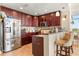 Well-equipped kitchen featuring dark wood cabinetry and a convenient breakfast bar at 101 S Eola Dr # 902, Orlando, FL 32801