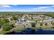 Aerial view featuring houses with pools and lake access, perfect for outdoor enjoyment at 130 Islabella Way, Groveland, FL 34736