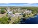 Waterfront community featuring multiple single Gathering homes and large lake at 130 Islabella Way, Groveland, FL 34736