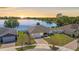 An aerial view showcases the house's proximity to a serene lake, with a well-maintained yard and a brick driveway at 130 Islabella Way, Groveland, FL 34736
