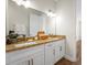 Bright bathroom featuring double vanities and granite counters at 130 Islabella Way, Groveland, FL 34736
