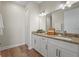 Bright bathroom featuring double vanities and granite counters at 130 Islabella Way, Groveland, FL 34736