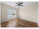 This bedroom boasts wood flooring and a large window with water views at 130 Islabella Way, Groveland, FL 34736