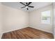 This bedroom boasts wood flooring and a large window at 130 Islabella Way, Groveland, FL 34736