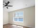 Bedroom with wood floors, fan, and water view from the window at 130 Islabella Way, Groveland, FL 34736