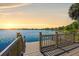 Sunset view from the wooden dock, creating a stunning and peaceful waterfront experience at 130 Islabella Way, Groveland, FL 34736