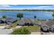 Lakefront home featuring lush landscaping and a brick driveway at 130 Islabella Way, Groveland, FL 34736