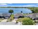 Lakefront home featuring lush landscaping and a brick driveway at 130 Islabella Way, Groveland, FL 34736