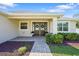 A welcoming front entrance features a brick walkway, double doors, and well-manicured landscaping at 130 Islabella Way, Groveland, FL 34736