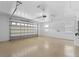 A spacious garage with sealed flooring and overhead lighting at 130 Islabella Way, Groveland, FL 34736