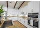 Bright kitchen features wooden floors, granite counters and modern, stainless steel appliances at 130 Islabella Way, Groveland, FL 34736