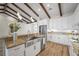 Bright kitchen with stainless steel appliances, granite counters, and hardwood floors at 130 Islabella Way, Groveland, FL 34736