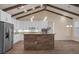 Modern kitchen with stainless steel appliances, white cabinets, and a wood-paneled island at 130 Islabella Way, Groveland, FL 34736