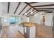 Open kitchen overlooking a screened lanai and a lake in the background at 130 Islabella Way, Groveland, FL 34736