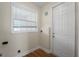 A laundry room with white walls, wood flooring and window at 130 Islabella Way, Groveland, FL 34736