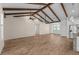 Spacious living room featuring exposed beams and tile flooring throughout the home at 130 Islabella Way, Groveland, FL 34736
