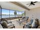 Relaxing screened patio with comfortable seating, providing a serene space overlooking the tranquil lake at 130 Islabella Way, Groveland, FL 34736