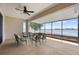 Covered patio featuring ceiling fan and expansive lake views, perfect for outdoor relaxation and entertaining at 130 Islabella Way, Groveland, FL 34736