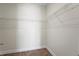 A walk-in closet with wood flooring and metal storage shelving at 130 Islabella Way, Groveland, FL 34736