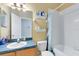Bright bathroom featuring a tub/shower, toilet, and vanity sink with storage at 14230 Sunriver Ave, Orlando, FL 32828