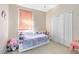 A bedroom with a pink shade and white closet doors at 14230 Sunriver Ave, Orlando, FL 32828