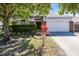 Charming single-story home featuring a well-maintained lawn and attractive landscaping with mature trees at 14230 Sunriver Ave, Orlando, FL 32828