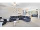 Bright living room with a large sectional sofa, neutral walls, and ample natural light at 14230 Sunriver Ave, Orlando, FL 32828
