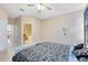 A corner view of main bedroom with ceiling fan and ensuite bath at 14230 Sunriver Ave, Orlando, FL 32828