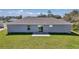 Back of house with concrete patio and green lawn at 14978 Sw 24Th Cir, Ocala, FL 34473