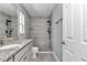 Contemporary bathroom featuring a stand-up shower with gray tile, and granite vanity at 14978 Sw 24Th Cir, Ocala, FL 34473