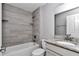 Bathroom features updated sink with granite countertop, bathtub, and tiled shower at 14978 Sw 24Th Cir, Ocala, FL 34473