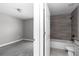 View of a neutral bathroom with an updated sink, bathtub, and tiled shower, with a door to bedroom at 14978 Sw 24Th Cir, Ocala, FL 34473