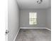Bedroom with a window featuring blinds, neutral paint and gray carpet at 14978 Sw 24Th Cir, Ocala, FL 34473