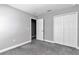 Neutral bedroom with a double door closet and gray carpet at 14978 Sw 24Th Cir, Ocala, FL 34473