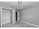 Neutral bedroom features an open closet and neutral paint and gray carpet at 14978 Sw 24Th Cir, Ocala, FL 34473