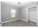 Bedroom with gray walls, carpeted floor, closet, and a window at 14978 Sw 24Th Cir, Ocala, FL 34473