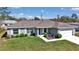 A charming one-story home with well-kept landscaping, gray exterior, and a two-car garage at 14978 Sw 24Th Cir, Ocala, FL 34473