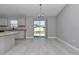 Dining room with tile floors and sliding doors to backyard with a kitchen at 14978 Sw 24Th Cir, Ocala, FL 34473