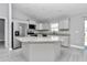 Spacious kitchen island complemented by stainless steel appliances and bright, modern cabinetry at 14978 Sw 24Th Cir, Ocala, FL 34473